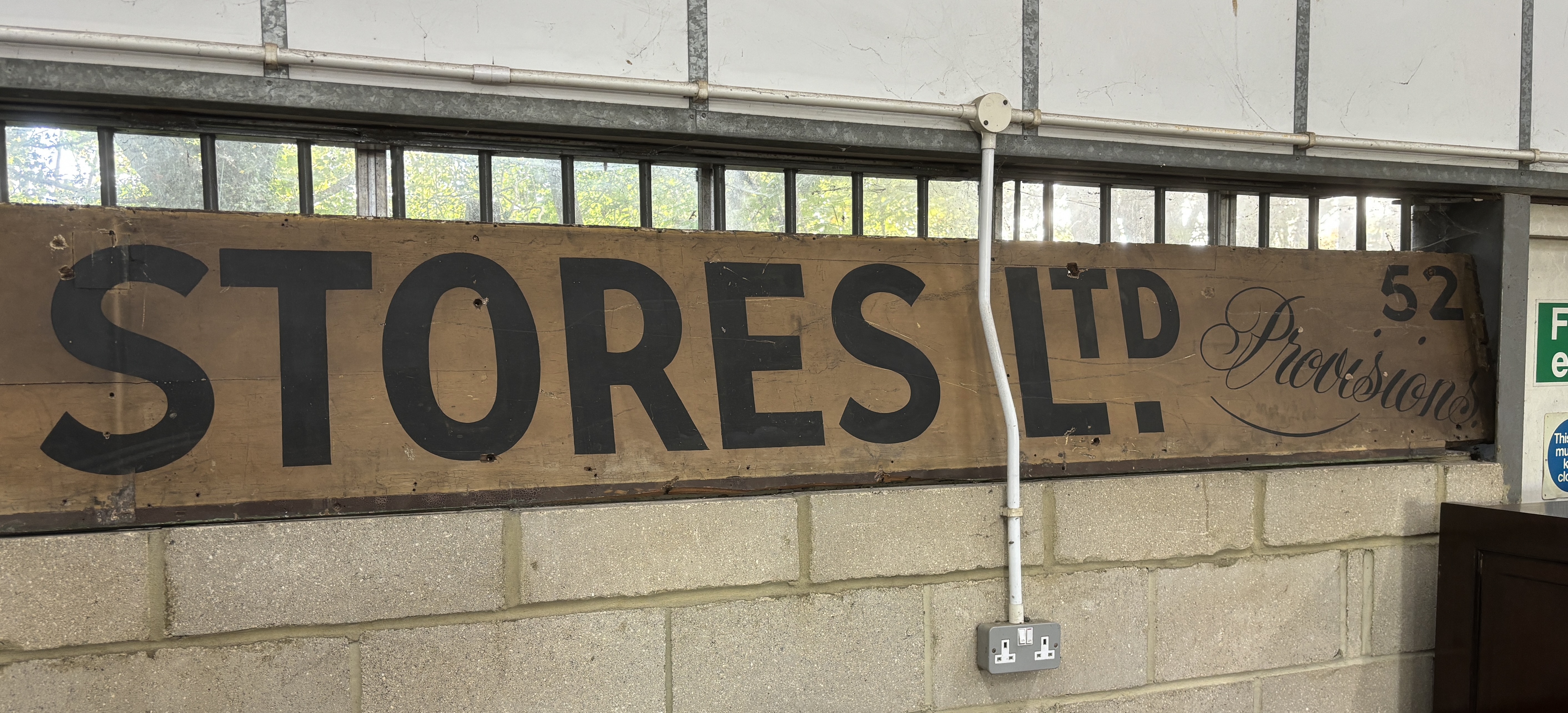 A vintage Partners Stores Limited shop sign, combined length approx. 540cm, height 44cm